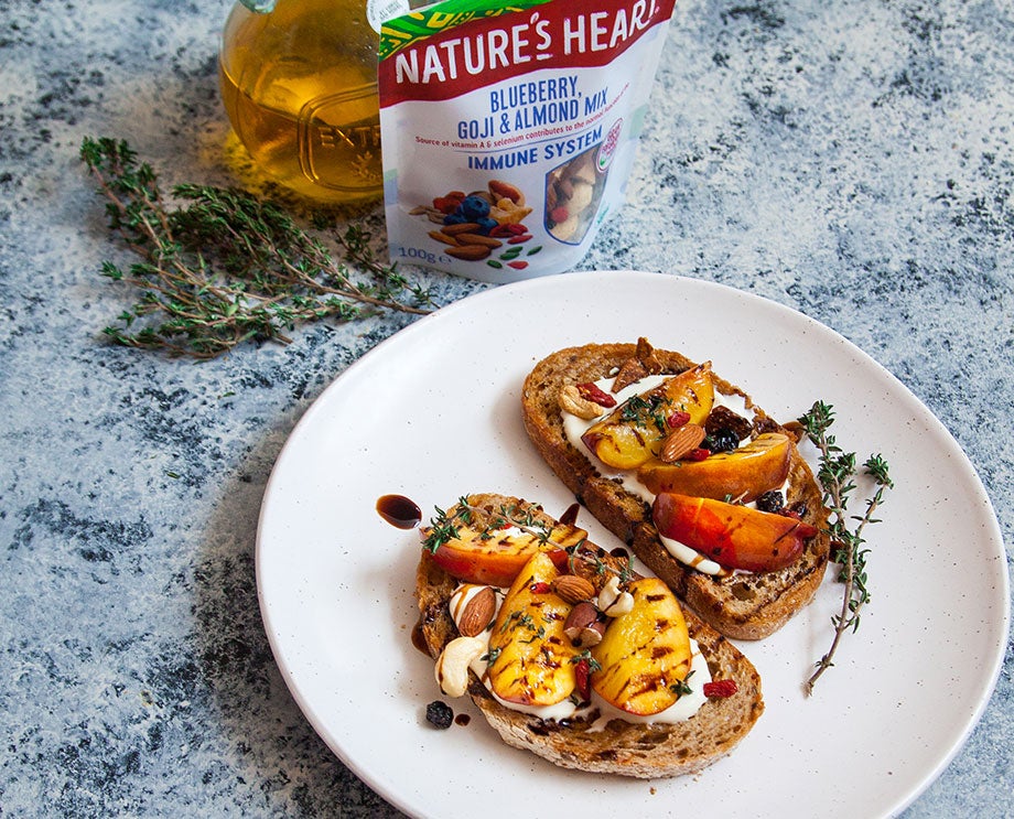 grilled peach tartine with blueberries almond and goji