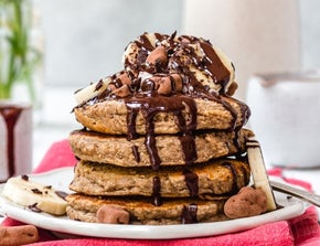 A stack of fluffy chocolate banana pancakes