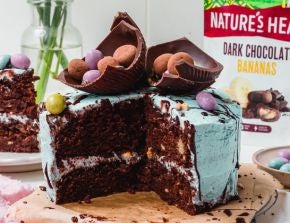 Chocolate Banana Easter Cake with a large slice cut out of it